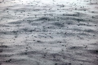 Rain drops on calm sea