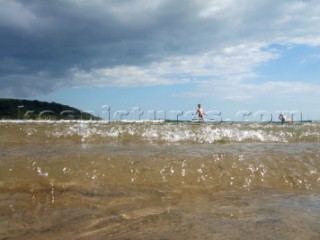 Waves and wabeletts lapping on a sandy beach