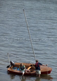 Couple landing ashore from a dinghy