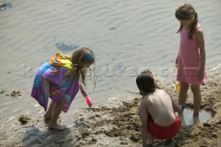 Kids, children and family playing on a sandy beach