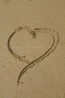 Heart drawn on wet sand