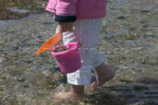 Detail of little girl with bucket and spade