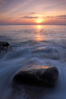 Slow effect of water over rocks at sunset