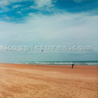 Man kite boarding on flat sandy beach near Aberdeen, Scotland