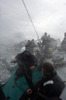 Extreme rough weather sailing shots onboard of the Volvo 70 ABN AMRO surfing downwind with wash, waves and spray on deck testing the teamwork and commitment of the crew