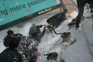 Extreme rough weather sailing shots onboard of the Volvo 70 ABN AMRO surfing downwind with wash, waves and spray on deck testing the teamwork and commitment of the crew