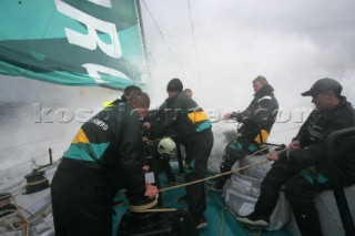 Extreme rough weather sailing shots onboard of the Volvo 70 ABN AMRO surfing downwind with wash, waves and spray on deck testing the teamwork and commitment of the crew