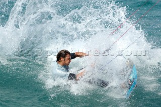 Kitesurfer crashing into water in strong winds