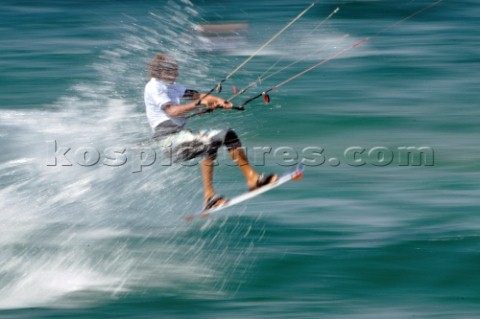 Kitesurfer gets air of a wave in strong winds