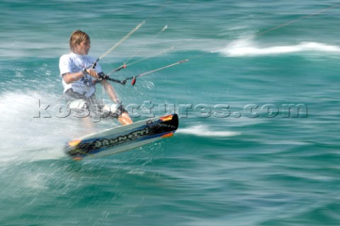 Kitesurfer carving through water in strong winds