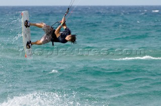 Kitesurfer gets big air off a wave in strong winds