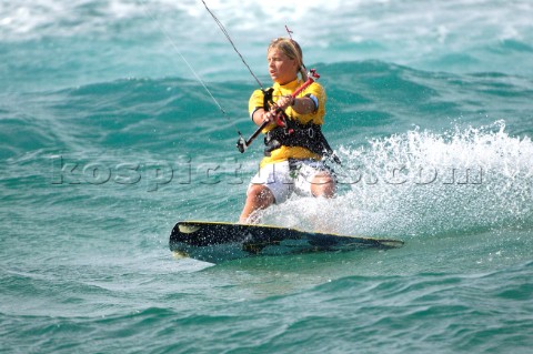 Kitesurfer carving through water in strong winds