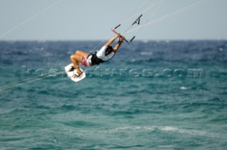 Kitesurfer tangled in kite lines in mid air