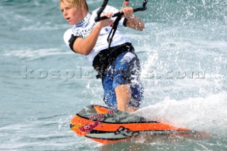 Kitesurfer carving through water in strong winds