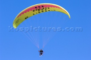 Motorised paradlider fyling in clear blue sky