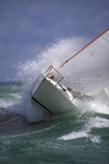 Yacht in large waves and rough sea