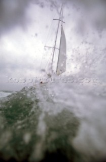 Yacht in large waves and rough sea