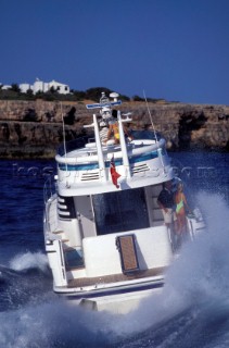 Male and female models relaxing and socialising on a luxury Fairline powerboat