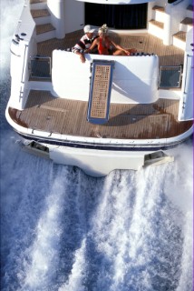 Male and female models relaxing and socialising on a luxury Fairline powerboat