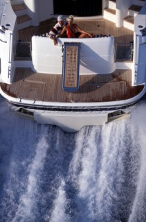 Male and female models relaxing and socialising on a luxury Fairline powerboat