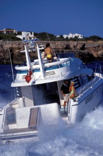 Male and female models relaxing and socialising on a luxury Fairline powerboat