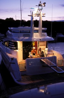 Male and female models relaxing and socialising on a luxury Fairline powerboat