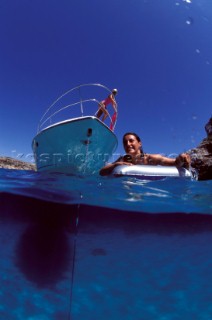 Male and female models relaxing and socialising on a luxury Fairline powerboat