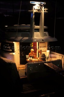 Male and female models relaxing and socialising on a luxury Fairline powerboat