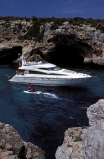 Male and female models relaxing and socialising on a luxury Fairline powerboat