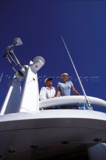 Male and female models relaxing and socialising on a luxury Fairline powerboat