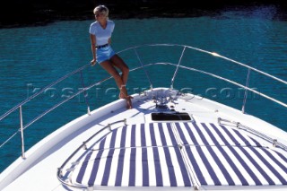 Male and female models relaxing and socialising on a luxury Fairline powerboat