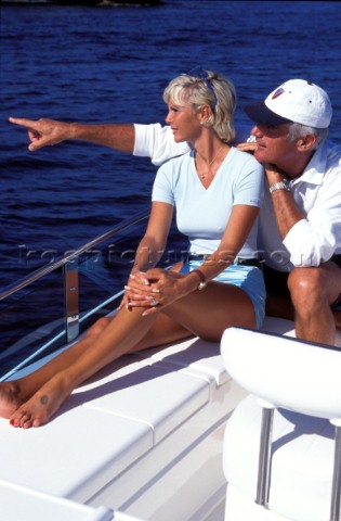 Male and female models relaxing and socialising on a luxury Fairline powerboat