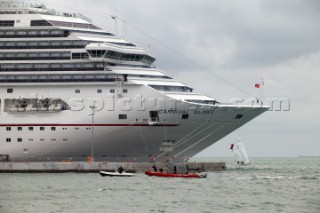 Police harbour patrol stop a RIB driver speeding in the port in front the bow of a cruise ship called Carnival Glory with a Melges 24 sailing dangerously close under the bow close to collision in Key West, Florida, USA. Key West