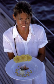 Professional crew hostess serving meal for dinner of lunch