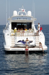 Mangusta powerboat superyacht at anchor in a tranquille bay