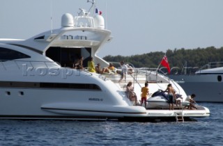 Mangusta powerboat superyacht at anchor in a tranquille bay