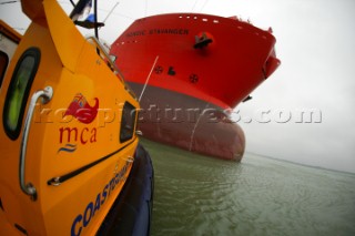 The unload Oil Shuttle Tanker Nordic Stavanger being approached by a coastguard boat