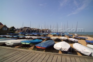 Covered boats sitting on the beach at Whitstable