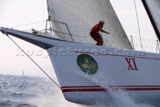 PORTO CERVO, SARDINIA - SEPT 9th 2006: The bowman onboard the canting keel maxi Wild Oats hangs on as the yacht crashes through a wave during racing in the Maxi Yacht Rolex Cup on September 9th 2006. Wild Oats comes 3rd in the IRC Racing Division overall. The Maxi Yacht Rolex Cup is the largest maxi regatta in the world, which attracts the fastest and most expensive sailing yachts to Porto Cervo, Sardinia bi-annually. (Photo by Tim Wright/Kos Picture Source via Getty Images)