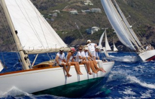 Crew sitting on the rail of a boat taking part in Antigua Classic Yacht Regatta April 2006