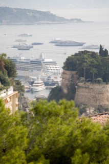 Mega yachts and superyachts moored in Monaco harbour, where cruise ships now also have berths