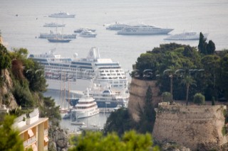 Mega yachts and superyachts moored in Monaco harbour, where cruise ships now also have berths