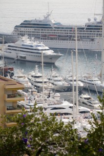 Mega yachts and superyachts moored in Monaco harbour, where cruise ships now also have berths