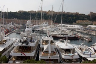 Mega yachts and superyachts moored in Monaco harbour, where cruise ships now also have berths