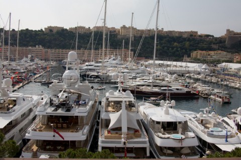 Mega yachts and superyachts moored in Monaco harbour where cruise ships now also have berths
