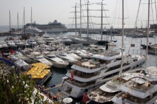 Mega yachts and superyachts moored in Monaco harbour, where cruise ships now also have berths