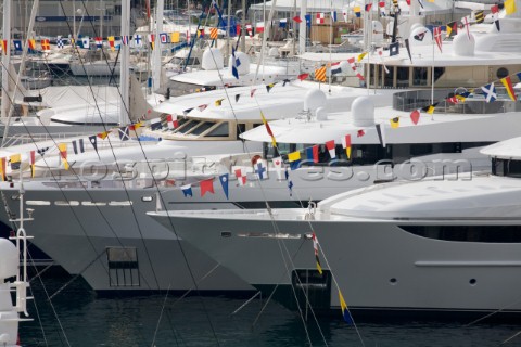 Signal flags and pennants on superyachts and mega yachts dressed overall moored in the busy port of 