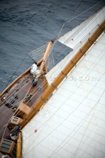 SAINT-TROPEZ, FRANCE - The bowman checks the rigging on the classic gaff rigged yacht Mariquita whilst charging upwind during racing in the Voiles de St Tropez on October 3rd 2006. The largest classic and modern yachts from around the world gather in Saint-Tropez annually for a week of racing and festivities to mark the end of the Mediterranean season, before heading across the Atlantic to winter in the Caribbean.