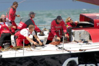 PORTSMOUTH, UNITED KINGDOM - MAY 29: James Cracknell, Olympic Gold Medalist Rower, takes shelter in the hatchway of the Volvo 70 Pirates of the Caribbean skippered by Paul Cayard, as they take 2nd place in the in-port race off the Isle of Wight. The Volvo Ocean Race 2005-2006 fleet race in each port between the long distance legs.