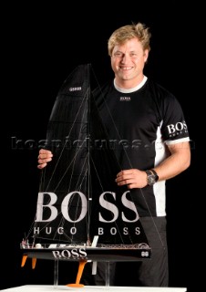 BILBAO, SPAIN - October 22nd 2006: Alex Thomson (GBR) skipper of Open 60 monohull HUGO BOSS with a model of his boat. The Velux 5 Oceans is a three part round the world yacht race for the bravest of solo sailors. Leg 1 is approximately 12,000 miles from Bilbao in Spain to Fremantle in Western Australia. It is the ultimate test of sailing skill, stamina and endurance. (Rights restrictions may apply)